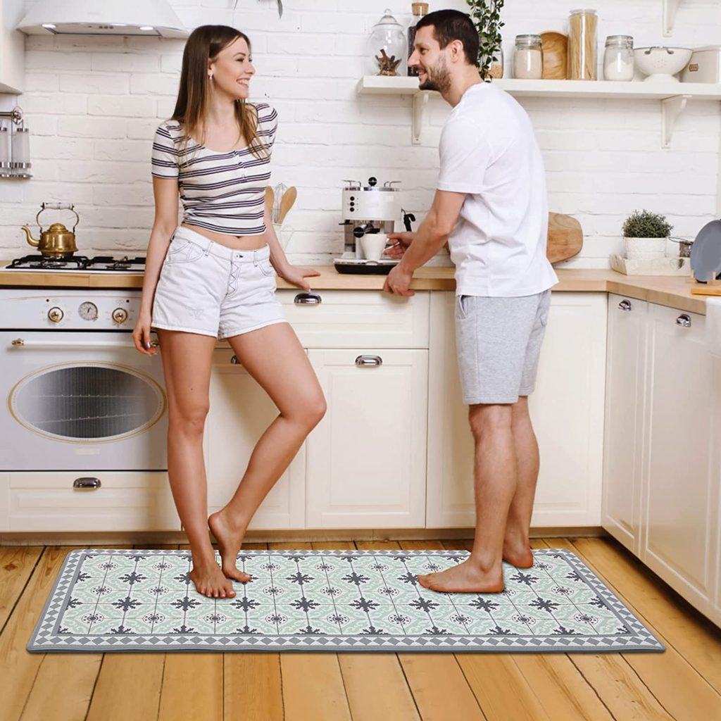 Vynil Kitchen Mat Green Geometric Pattern with happy couple standing on it